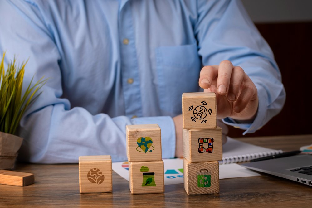 Wooden blocks with sustainability icons representing social impact