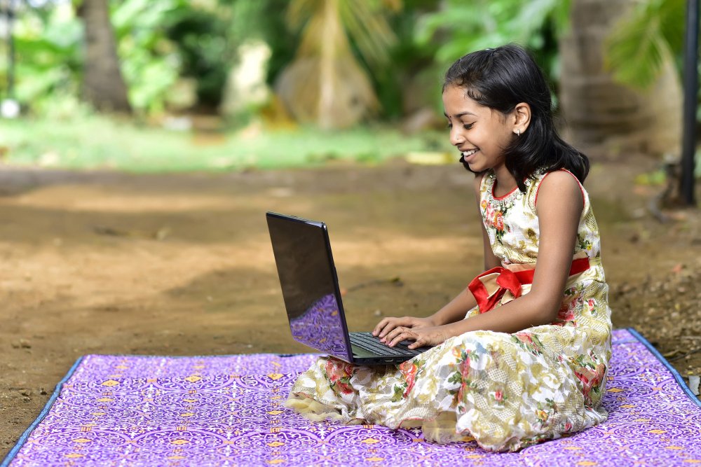 Young girl using a laptop for online learning
