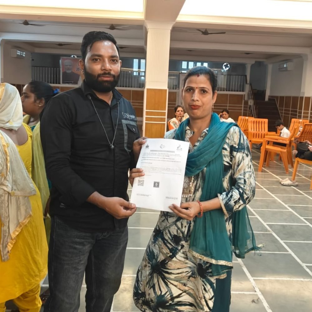 Sunil Foundation representative handing a certificate to a woman